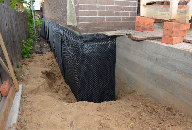 SJ Waterproofing Pros technician performing targeted Wet Basement Repair assessment in Elwood, IL